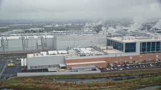 5.5K aerial stock footage of the Intel manufacturing plant at Intel Ronler Acres Campus and low clouds, autumn, Hillsboro, Oregon Aerial Stock Footage | AX153_001