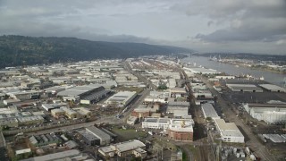 5.5K aerial stock footage flying by warehouses along the river, autumn, Northwest Portland, Oregon Aerial Stock Footage | AX153_059