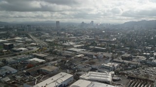 5.5K aerial stock footage flying over warehouses and parking lots toward Downtown, Northwest Portland, Oregon Aerial Stock Footage | AX153_066E