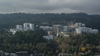 AX153_082 - 5.5K aerial stock footage of a reverse view of the Oregon Health and Science University in Portland, Oregon