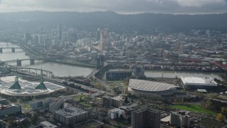 5.5K aerial stock footage orbiting office buildings and Moda Center with Downtown Portland, Oregon in the background Aerial Stock Footage | AX153_111E