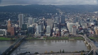 AX153_121 - 5.5K aerial stock footage of skyscrapers and Morrison Bridge seen from across the Willamette River, Downtown Portland, Oregon