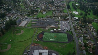 AX153_168E - 5.5K aerial stock footage orbiting an elementary school and high school in Washougal, Washington