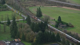 AX153_172 - 5.5K aerial stock footage tracking a train in Washougal, Washington