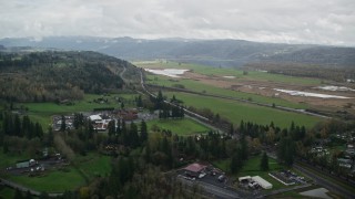 AX153_176E - 5.5K aerial stock footage approaching a train traveling through Washougal, Washington