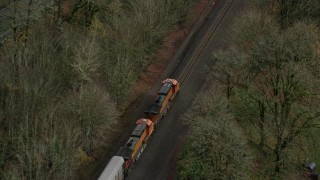 5.5K aerial stock footage of a bird's eye tracking a train traveling into Columbia River Gorge, Oregon Aerial Stock Footage | AX153_180E