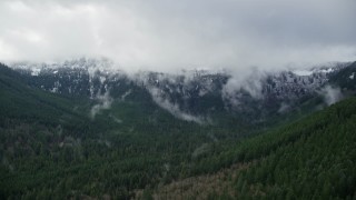 5.5K aerial stock footage of snowy mountains at the end of a canyon with evergreen trees in Cascade Range, Hood River County, Oregon Aerial Stock Footage | AX154_057