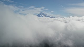 5.5K aerial stock footage approaching Mount Hood, visible above a layer of thick clouds, Cascade Range, Oregon Aerial Stock Footage | AX154_060E