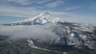 5.5K aerial stock footage of low clouds over snowy forest near Mount Hood, Cascade Range, Oregon Aerial Stock Footage | AX154_108E