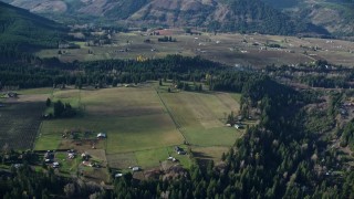 5.5K aerial stock footage flying by rural farms and fields in Parkdale, Oregon Aerial Stock Footage | AX154_143E