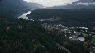 5.5K aerial stock footage flying over forest by Interstate 84 to approach Bridge of the Gods, Cascade Locks, Oregon in Columbia River Gorge Aerial Stock Footage | AX154_169E