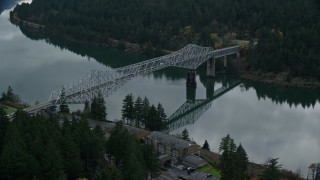 AX154_172E - 5.5K aerial stock footage flying over small town RV park and hotel to approach the Bridge of the Gods, Cascade Locks, Oregon in Columbia River Gorge