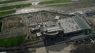 AX154_220E - 5.5K aerial stock footage approaching the control tower and parking structure at the Portland International Airport, Oregon