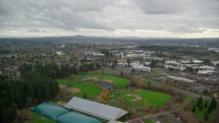 AX155_008E - 5.5K aerial stock footage flying over shopping center and Tualatin Hills Sports Complex, approach Nike Headquarters, Beaverton, Oregon