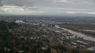 5.5K aerial stock footage flying by hillside homes to reveal condo high-rises by the Willamette River in South Waterfront, Portland, Oregon Aerial Stock Footage | AX155_018E