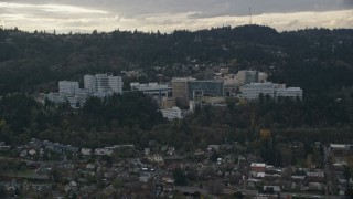 AX155_079 - 5.5K aerial stock footage of Oregon Health and Science University in the hills over Portland, Oregon