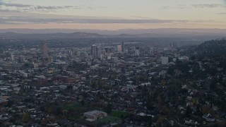 5.5K aerial stock footage of Mount Hood and Downtown Portland at sunset, seen from evergreen forest and hills in Northwest Portland, Oregon Aerial Stock Footage | AX155_140E