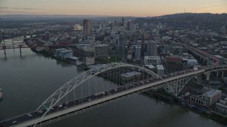 5.5K aerial stock footage fly over heavy traffic on the Fremont Bridge at twilight, Downtown Portland in the background, Oregon Aerial Stock Footage | AX155_161E