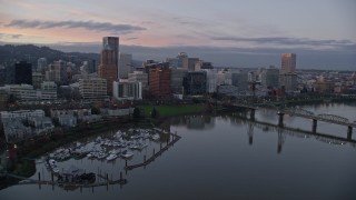 AX155_202 - 5.5K aerial stock footage flying over Hawthorne Bridge, and pass the downtown skyline at twilight, Downtown Portland, Oregon