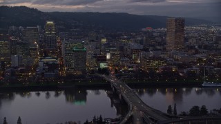 5.5K aerial stock footage passing skyscrapers and the Morrison Bridge over the Willamette River at twilight, Downtown Portland, Oregon Aerial Stock Footage | AX155_253