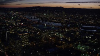 5.5K aerial stock footage flying over convention center to approach the Willamette River and Downtown Portland at night in Oregon Aerial Stock Footage | AX155_299E