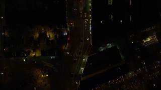 5.5K aerial stock footage of a bird's eye of dark streets and SW Broadway in downtown at nighttime, reveal Pioneer Courthouse Square Downtown Portland, Oregon Aerial Stock Footage | AX155_350E