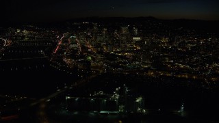 5.5K aerial stock footage of Downtown skyscrapers and bridges over the Willamette River at nighttime, Downtown Portland, Oregon Aerial Stock Footage | AX155_363E