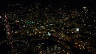 5.5K aerial stock footage approach skyscrapers, high-rises, and White Stag sign from Burnside Bridge at night, Downtown Portland, Oregon Aerial Stock Footage | AX155_431E