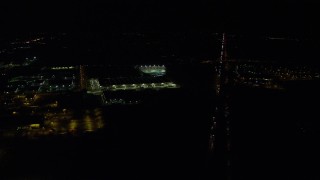 5.5K aerial stock footage following Highway 26 to approach a warehouse building and Topgolf course in Hillsboro, Oregon at nighttime Aerial Stock Footage | AX155_474