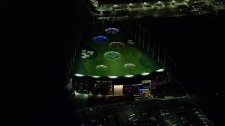 AX155_477E - 5.5K aerial stock footage orbiting a Topgolf course in Hillsboro, Oregon at night