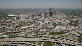 AX36_002E - 4.8K aerial stock footage flying over freeways toward Downtown Atlanta skyscrapers, Georgia