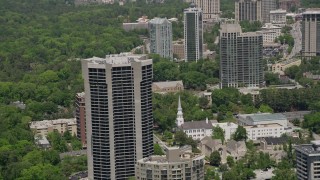 AX36_051E - 4.8K aerial stock footage pass condo high-rise to reveal a church, Buckhead, Georgia