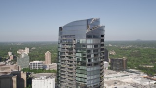 AX38_022 - 4.8K aerial stock footage orbiting the top of 3344 Peachtree skyscraper, Buckhead, Georgia