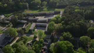 4.8K aerial stock footage approaching abandoned buildings among trees, West Atlanta Aerial Stock Footage | AX38_084