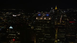 AX41_011E - 4.8K aerial stock footage orbit the tops of skyscrapers, Downtown Atlanta, Georgia, night