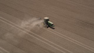 5K aerial stock footage of tracking a tractor as it tills a field, Camarillo, California Aerial Stock Footage | AX42_036