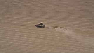 5K aerial stock footage approach and track a tractor tilling a field, Camarillo, California Aerial Stock Footage | AX42_039