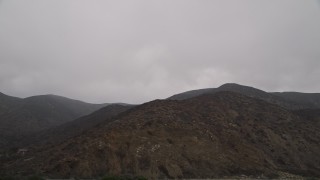 AX42_063 - 5K aerial stock footage of flying by barren Santa Monica Mountains, Malibu, California