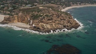 5K aerial stock footage tilt from the ocean to reveal and approach the rugged cliffs of Point Dume, Malibu, California Aerial Stock Footage | AX42_095