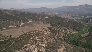 5K aerial stock footage fly over Santa Monica Mountains to approach Mulholland Highway, California Aerial Stock Footage | AX42_115