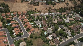 5K aerial stock footage reverse view of tract homes with swimming pools in Calabasas, California Aerial Stock Footage | AX42_118