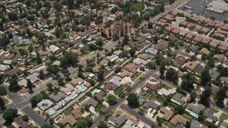 AX42_119 - 5K aerial stock footage of a reverse view of suburban residential neighborhoods, West Hills, California