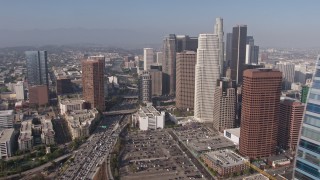 AX43_022E - 4K aerial stock footage flying by Ritz-Carlton toward I-110 and Downtown skyscrapers, Los Angeles, California