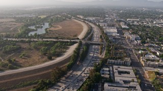 AX43_065 - 4K aerial stock footage following heavy I-405 traffic by Woodley Park, Van Nuys, California, approach the Burbank Boulevard overpass