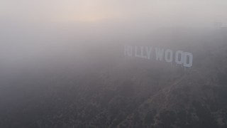 4K aerial stock footage orbiting Hollywood Sign and radio tower cloaked in Marine Layer, California, sunset Aerial Stock Footage | AX44_023E