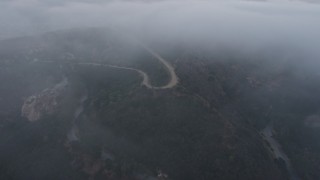 4K aerial stock footage of winding roads in fog, Hollywood Hills, California, sunset Aerial Stock Footage | AX44_029E