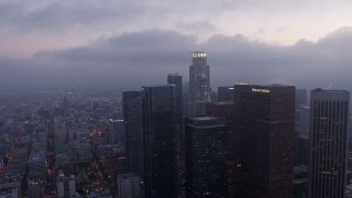 4K aerial stock footage orbiting skyscrapers and high-rises below marine layer, Downtown Los Angeles, twilight Aerial Stock Footage | AX44_050