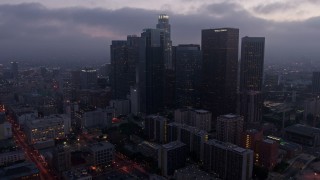 4K aerial stock footage approaching and tilting down on US Bank Tower, Downtown Los Angeles, twilight Aerial Stock Footage | AX44_054