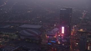 AX44_060 - 4K aerial stock footage approaching Staples Center panning to The Ritz-Carlton, Los Angeles, twilight