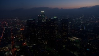 4K aerial stock footage flying by skyscrapers tracking US Bank Tower, Downtown Los Angeles, twilight Aerial Stock Footage | AX44_074